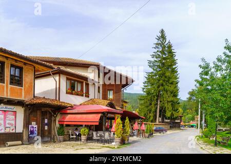 Koprivshtitsa, Bulgaria - September 24, 2023: Street scene with cafe, shops, locals, and visitors, in Koprivshtitsa, Bulgaria Stock Photo