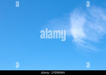 Cloudy blue sky, white clouds background with deep blue sky. Wallpaper with sunlight. Texture, pattern idea concept. Horizontal photo. No people. Stock Photo