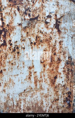 Close-up view of a rusty metal surface with natural corrosion patterns displaying a textured weathering effect, decay concept. Stock Photo