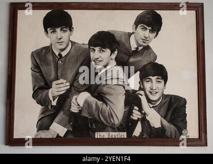 Vintage photo Portrait of The Beatles musical band group. Old textured vintage black and white photograph 1960s-70s. The Beatles' photo on the wall of Stock Photo