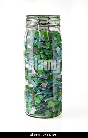 glass jar with blue and green shards of sea glass isolated on white background. Stock Photo