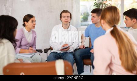 Group of students studying for difficult test in studygroup together Stock Photo