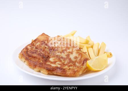 Tasty fish in soda water batter, potato chips and lemon slice isolated on white Stock Photo