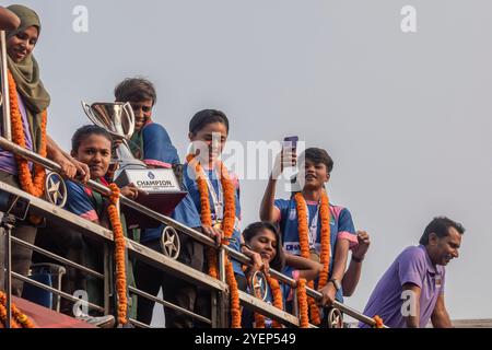 Dhaka, Bangladesh. 31st Oct, 2024. Bangladesh captain Sabina Khatun holds the SAFF Women's Championship trophy in an open-top bus during the celebration. Bangladesh national women's football team held the SAFF Women's Championship trophy in an open-top bus on their way to the BFF House from the Hazrat Shahjalal International Airport. Credit: SOPA Images Limited/Alamy Live News Stock Photo