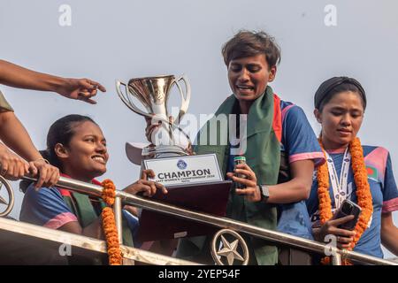 Dhaka, Bangladesh. 31st Oct, 2024. Bangladesh captain Sabina Khatun holds the SAFF Women's Championship trophy in an open-top bus during the celebration. Bangladesh national women's football team held the SAFF Women's Championship trophy in an open-top bus on their way to the BFF House from the Hazrat Shahjalal International Airport. Credit: SOPA Images Limited/Alamy Live News Stock Photo