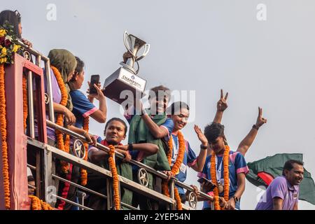 Dhaka, Bangladesh. 31st Oct, 2024. Bangladesh captain Sabina Khatun holds the SAFF Women's Championship trophy in an open-top bus during the celebration. Bangladesh national women's football team held the SAFF Women's Championship trophy in an open-top bus on their way to the BFF House from the Hazrat Shahjalal International Airport. Credit: SOPA Images Limited/Alamy Live News Stock Photo