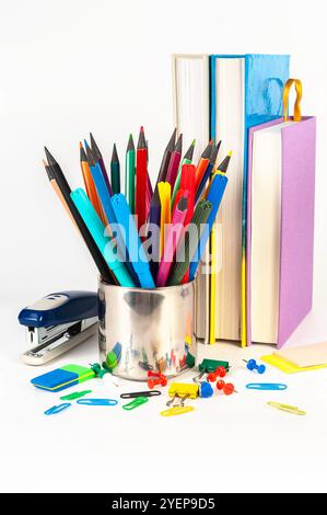 A collection of vibrant office supplies featuring a stapler, paper clips, binder clips, push pins, erasers, and rubber bands. Ideal for organizing wor Stock Photo