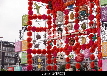 Colorful Day of the Dead (Dia de Muertos) altar adorned with marigold flowers, skulls, and traditional Mexican items in Mexico City's Zócalo square Stock Photo