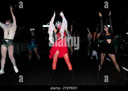 New York, United States. 31st Oct, 2024. Costumed parade goers dance during the 51st Annual Village Halloween Parade in New York, NY, on October 31, 2024. (Photo by Erin Lefevre/NurPhoto) Credit: NurPhoto SRL/Alamy Live News Stock Photo