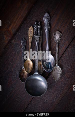 Silver spoons over a wood table Stock Photo