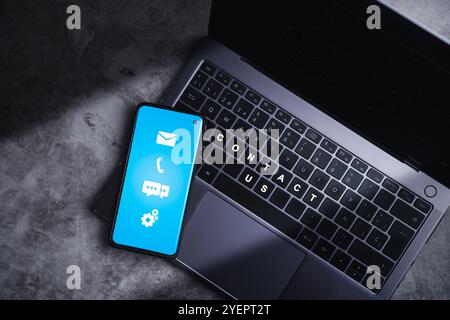 Top view of smartphone showing on screen address, phone, email and call icons for contact customer support. Help from mail websites digital technology Stock Photo