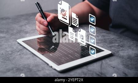 Woman use digital tablet selecting checkboxes for employment forms. Online assessments. Personal selection and human resource management. Stock Photo