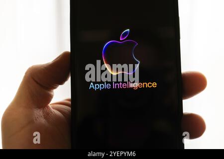 Hand holding iPhone with Apple logo and the text 'Apple Intelligence', bright and modern illustration, symbolic image of artificial intelligence Stock Photo