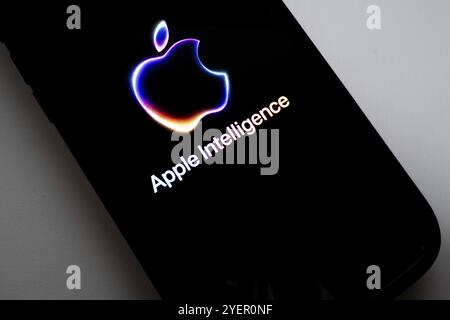 Apple logo on iPhone and the text 'Apple Intelligence', bright and modern image, symbolising artificial intelligence Stock Photo