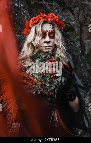 Closeup portrait of Calavera Catrina. Young woman with sugar skull makeup and red flowers. Dia de los muertos. Day of The Dead. Halloween. Santa Muert Stock Photo