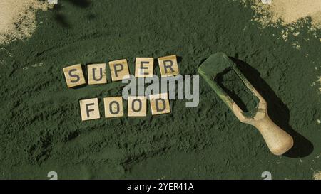 SUPERFOOD letter chlorella on green background of algae superfood. Organic blue-green algae spirulina powder food. Healthy benefits of natural supplem Stock Photo