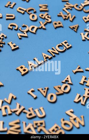 Word BALANCE made out of wooden letters on bright blue background. Motivational Words Quotes Concept. Inspirational phrase Stock Photo