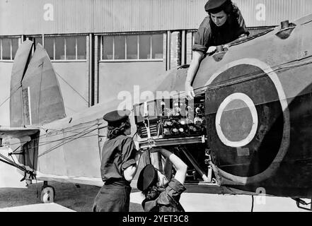 Women's Royal Naval Service aka WRENS servicing the radio equipment of a Fairey Swordfish, a biplane torpedo bomber, nicknamed 'Stringbag', and principally operated by the Fleet Air Arm of the Royal Navy. Originating in the early 1930s, the Swordfish initially operated primarily as a fleet attack aircraft, but in later years was increasingly used as an anti-submarine and training platform performing frontline service throughout the Second World War. Stock Photo