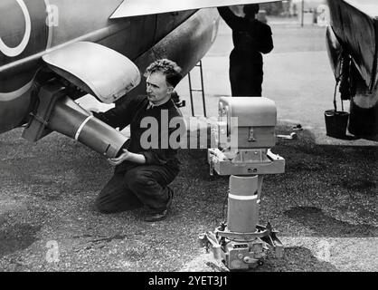 Ground crew installing F.52 vertical cameras with 20-inch lens reconnaisance cameras on a de Havilland DH.98 Mosquito, a British twin-engined, multirole combat aircraft, introduced during the Second World War. Unusual in that its airframe was constructed mostly of wood and so nicknamed the 'Wooden Wonder', or 'Mossie'. Originally conceived as an unarmed fast bomber, the Mosquito's use evolved during the war into many roles, including  photo-reconnaissance. Stock Photo