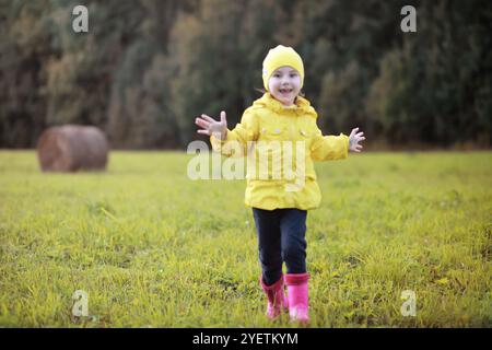 Children in village walk through the autumn forest and gather mushrooms. Children in nature are walking in nature. Rural walk in autumn. Stock Photo