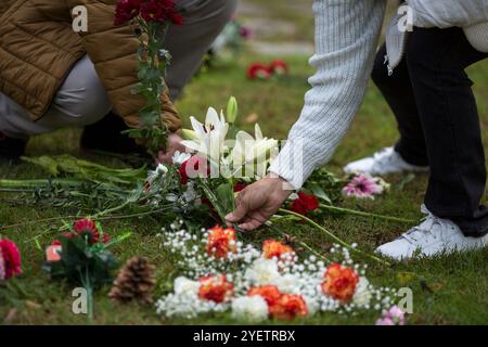 Madrid, Spain. 01st Nov, 2024. People place bouquets of flowers in the Garden of Remembrance at the Almudena Cemetery, during the celebration of All Saints' Day. The Almudena cemetery is named after the patron saint of Madrid and is the largest cemetery in Western Europe. Credit: SOPA Images Limited/Alamy Live News Stock Photo