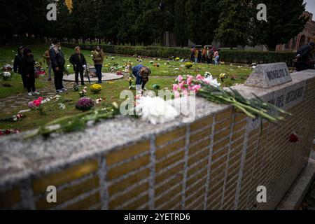 Madrid, Spain. 01st Nov, 2024. People place bouquets of flowers in the Garden of Remembrance at the Almudena Cemetery, during the celebration of All Saints' Day. The Almudena cemetery is named after the patron saint of Madrid and is the largest cemetery in Western Europe. Credit: SOPA Images Limited/Alamy Live News Stock Photo