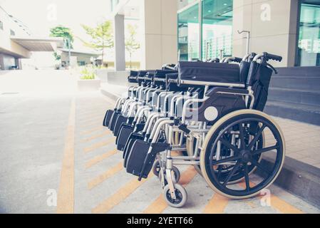 Rows of wheelchairs parking for disability patient services in medical hospital with copy space. Group of wheelchairs Row service at hospital Stock Photo