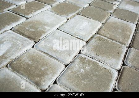 Background from a gray sidewalk path. Close-up of paving slabs. Stock Photo