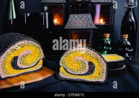 Colorful Swirled Bread with a Halloween Theme: Sliced milkbread colored with turmeric, matcha, purple sweet potato, and activated charcoal Stock Photo