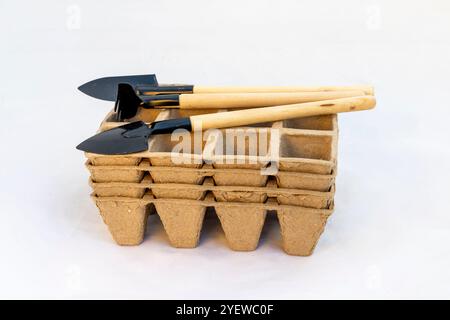 Biodegradable Seed Starter Tray Stack with Mini Gardening Shovels Stock Photo