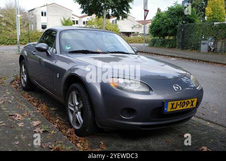 Amersfoort, Netherlands - Oct 13 2024 Front view on a parked grey Mazda MX5 from 2007 Stock Photo