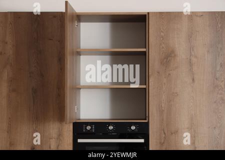 Open cupboard with shelves in modern kitchen interior Stock Photo