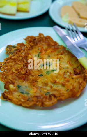 Traditional Andalusian dish from deep roasted potato and seafood, Tortillitas de Camarones, Shrimp Fritters served in old tavern as tapas, Sanlucar de Stock Photo