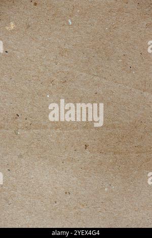 Macro photography of the texture of a brown sheet of kraft paper, with some marks of folds on it. Stock Photo