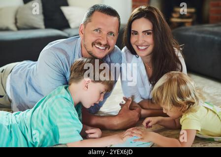 Happy family, tablet or parents playing with siblings or smile for bonding or child development. Mother, father or kids streaming online together with Stock Photo