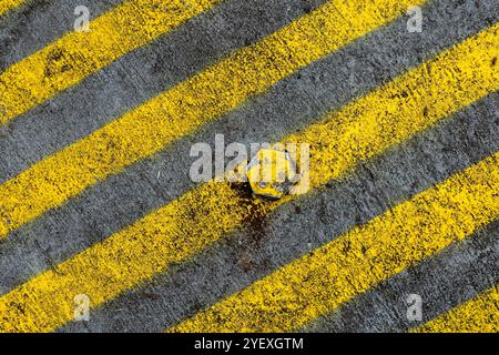 Bold yellow lines on roadway form a pleasing abstract image. Stock Photo