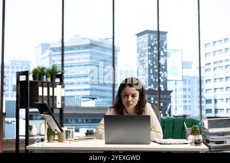 Female director reviewing sales reports and market trends from analytics, using data driven insights to obtain funding and maximize business development opportunities. Strategic thinking. Stock Photo