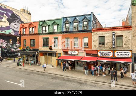 Montreal Schwartz's Deli. Famous Jewish Deli Schwartz Schwartzs Charcuterie Hebraique de Montréal, Quebec, Canada. Street art mural of Leonard Cohen. Stock Photo