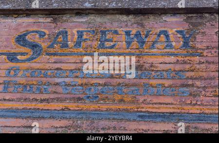 Vintage Multi Colored Old Safeway Grocery Text Letter Sign on Weathered Old Building Wall Facade, Jerome Arizona Southwest USA Stock Photo
