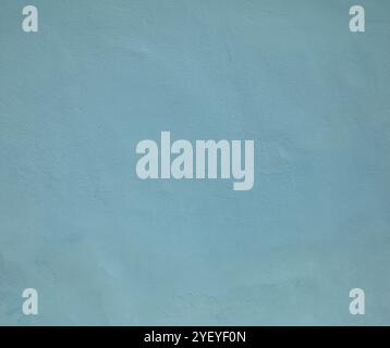 Blue or dark-blue wall, texture, background. The building wall, painted with water-based paint. Pale (flat) surface and backdrop in soft blue color Stock Photo