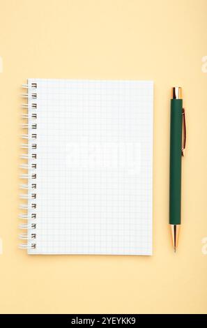Notebooks and pen on beige background, top view Stock Photo