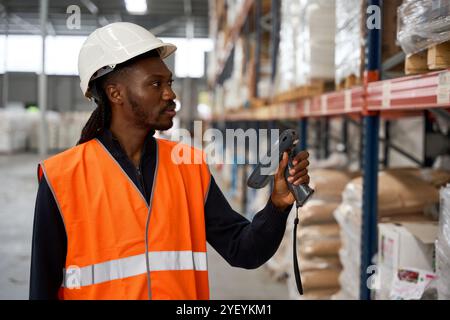Warehouse worker scanning packages with barcode scanner Stock Photo