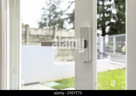 Aluminum window open detail. Metal door frame closeup view. Sound insulation. Energy efficient, safety profile, blur garden outdoor background. Stock Photo