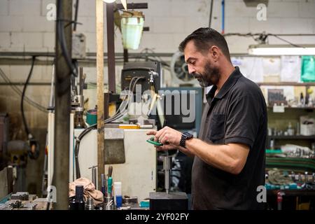 Smiling workers discussing production in mechanical parts factory Stock Photo