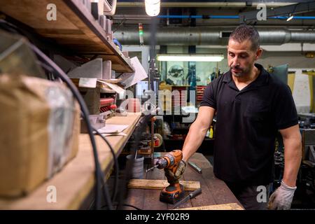 Metalworker operating cnc milling machine in factory Stock Photo