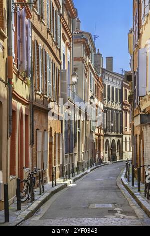 Narrow street in Toulouse historical center, France, Europe Stock Photo