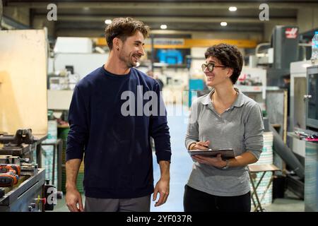 Metalworker checking inventory of steel parts in factory Stock Photo