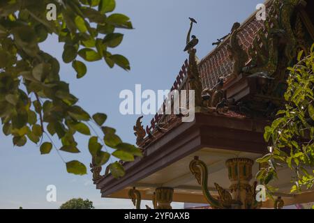 Peaceful pigeons perched on a golden monument surrounded by lush ...