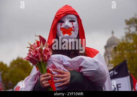 London, UK. 2nd November 2024.A pro-Palestine protester outside Downing Street wears a mask and holds a sheet representing Palestinian baby killed by Israel, as thousands march in Central London in solidarity with Palestine and Lebanon. Credit: Vuk Valcic/Alamy Live News Stock Photo