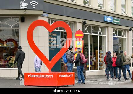 Akureyri, Iceland - 24 August 2024: People around a heart shaped Love Akureyri sculpture in the city centre Stock Photo